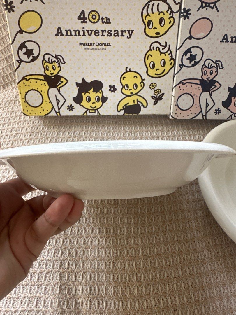 Osamu harada set plate (Category: Coffee & Tea Tableware) located in Cainta. Submitted by shopbyyna (Listing ID 1437413806, Image 3). Description: - Mister Donut 40th Anniversary medium Saucer Set plate - Includes two saucers - Each saucer features a unique cartoon character design - White, rounded shape - Comes with original boxes - Boxes feature cartoon illustrations and Mister Donut logo.