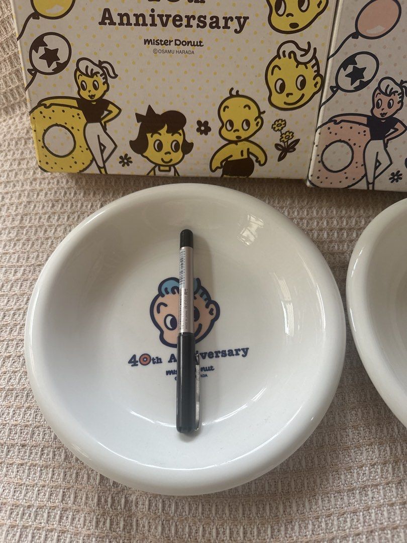 Osamu harada set plate (Category: Coffee & Tea Tableware) located in Cainta. Submitted by shopbyyna (Listing ID 1437413806, Image 2). Description: - Mister Donut 40th Anniversary medium Saucer Set plate - Includes two saucers - Each saucer features a unique cartoon character design - White, rounded shape - Comes with original boxes - Boxes feature cartoon illustrations and Mister Donut logo.