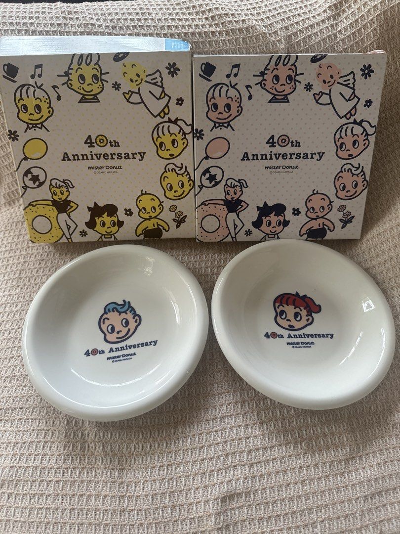 Osamu harada set plate (Category: Coffee & Tea Tableware) located in Cainta. Submitted by shopbyyna (Listing ID 1437413806, Image 1). Description: - Mister Donut 40th Anniversary medium Saucer Set plate - Includes two saucers - Each saucer features a unique cartoon character design - White, rounded shape - Comes with original boxes - Boxes feature cartoon illustrations and Mister Donut logo.