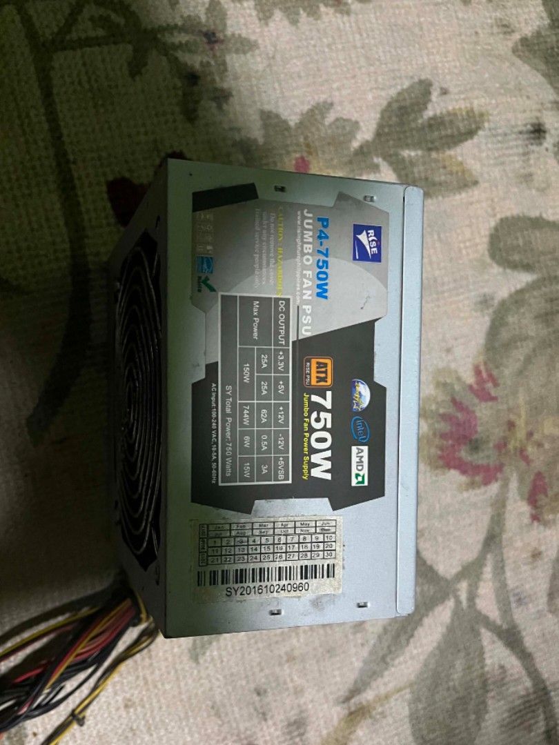 P4-750W Jumbo Fan PSU (Category: Computer Parts) located in Manila. Submitted by benmatthew46454 (Listing ID 1437512943, Image 1). Description: P4-750W Jumbo Fan PSU. It has a 750W output. The unit has multiple connectors for various components. The fan is visible on the side. The unit has a sticker with serial number. The unit is silver and black..