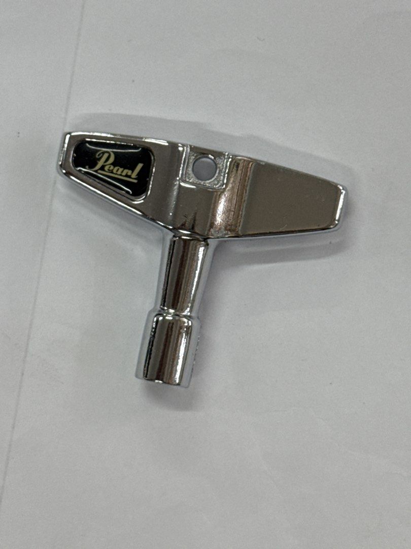 Pearl Drum Key K050 (Category: Musical Instruments) located in Quezon City. Submitted by wanderlasss (Listing ID 1437475629, Image 2). Description: Genuine Pearl drum key. This key is designed for tuning drums. It features a T-handle for easy grip and leverage. The Pearl logo is clearly visible on the key. A must-have for any drummer. free generic drum key and miscellaneous hardware.