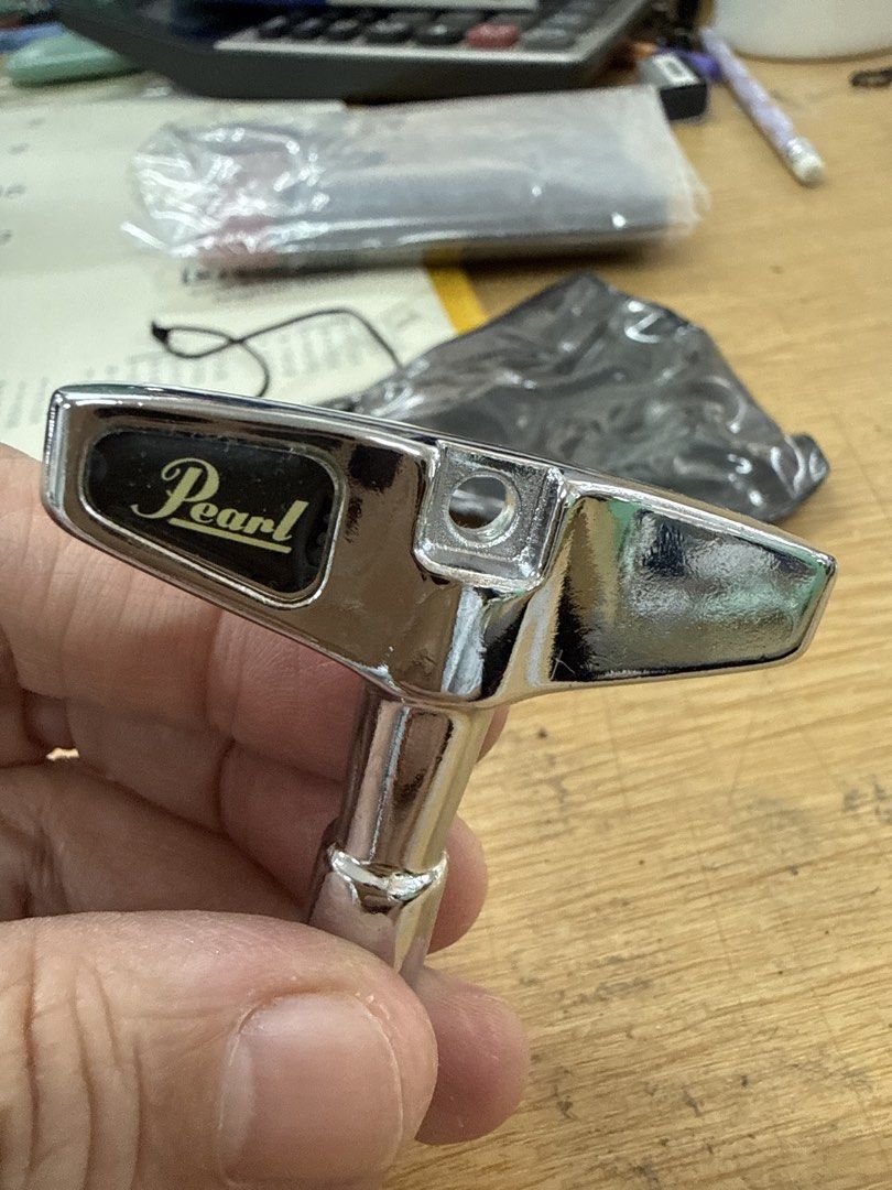Pearl Drum Key K050 (Category: Musical Instruments) located in Quezon City. Submitted by wanderlasss (Listing ID 1437475629, Image 1). Description: Genuine Pearl drum key. This key is designed for tuning drums. It features a T-handle for easy grip and leverage. The Pearl logo is clearly visible on the key. A must-have for any drummer. free generic drum key and miscellaneous hardware.