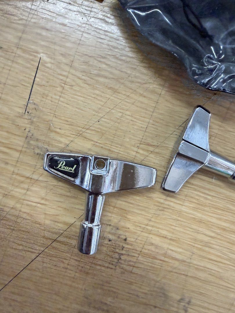 Pearl Drum Key K050 (Category: Musical Instruments) located in Quezon City. Submitted by wanderlasss (Listing ID 1437475629, Image 3). Description: Genuine Pearl drum key. This key is designed for tuning drums. It features a T-handle for easy grip and leverage. The Pearl logo is clearly visible on the key. A must-have for any drummer. free generic drum key and miscellaneous hardware.