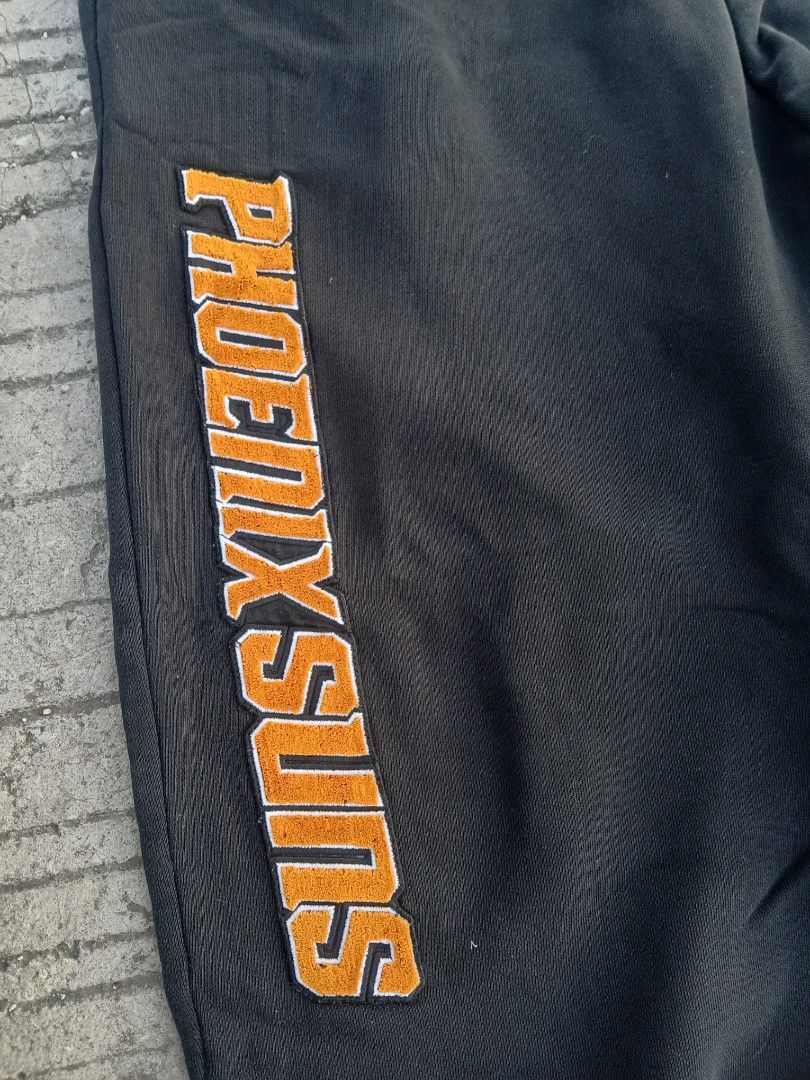 Phoenix Suns NBA Sweatpants XXL (Category: Joggers) located in Manila. Submitted by thrift_sixty (Listing ID 1437487689, Image 3). Description: - XXL Phoenix Suns sweatpants - Features the Phoenix Suns logo in orange - Includes NBA logo patch - Drawstring waist - Soft, comfortable fabric.