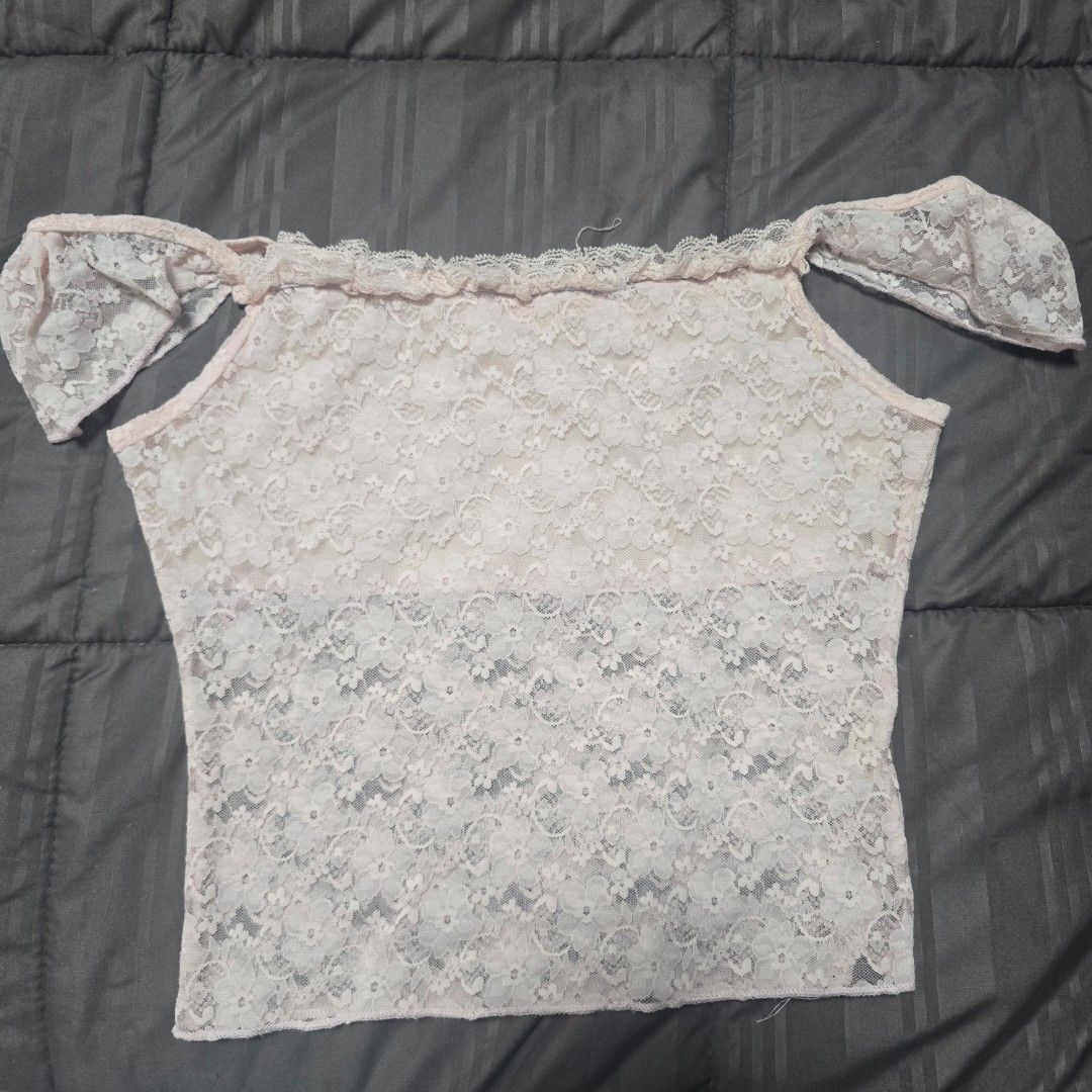 Pink Floral Lace Top (Category: Sleeveless) located in Adams. Submitted by declutter.seasonnn (Listing ID 1437411777, Image 3). Description: - Light pink lace top - Asymmetrical design - Single shoulder strap - Small bow detail - Ruffled trim - Lightweight and semi-sheer fabric - Perfect for layering.