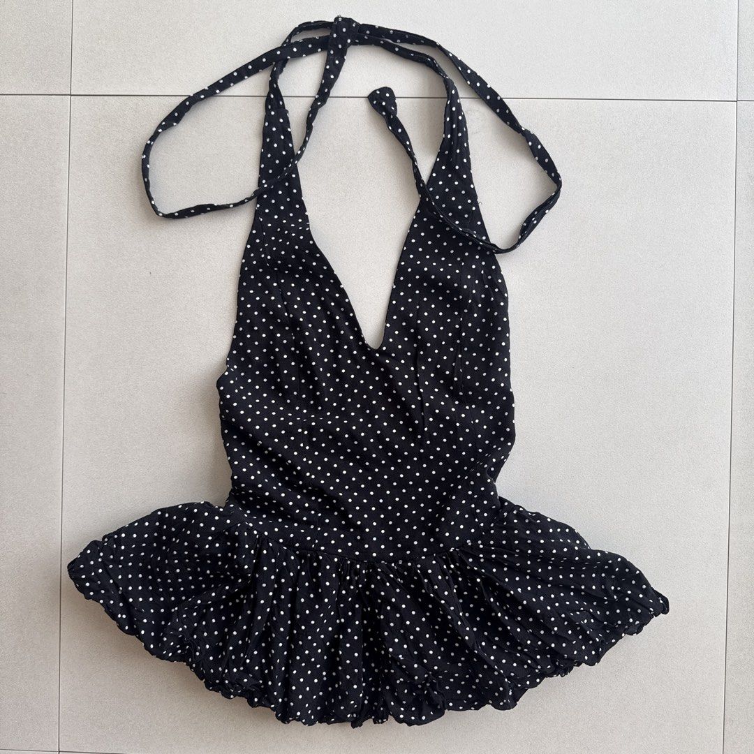 Polka Dot Halter Top (Category: Sleeveless) located in Cebu City. Submitted by strawbeanz (Listing ID 1437460941, Image 2). Description: - Black halter top with white polka dots - V-neckline - Tie-up straps - Ruffled hem - Gathered front detail - Lightweight fabric - Suitable for warm weather - Unique design and flattering silhouette.