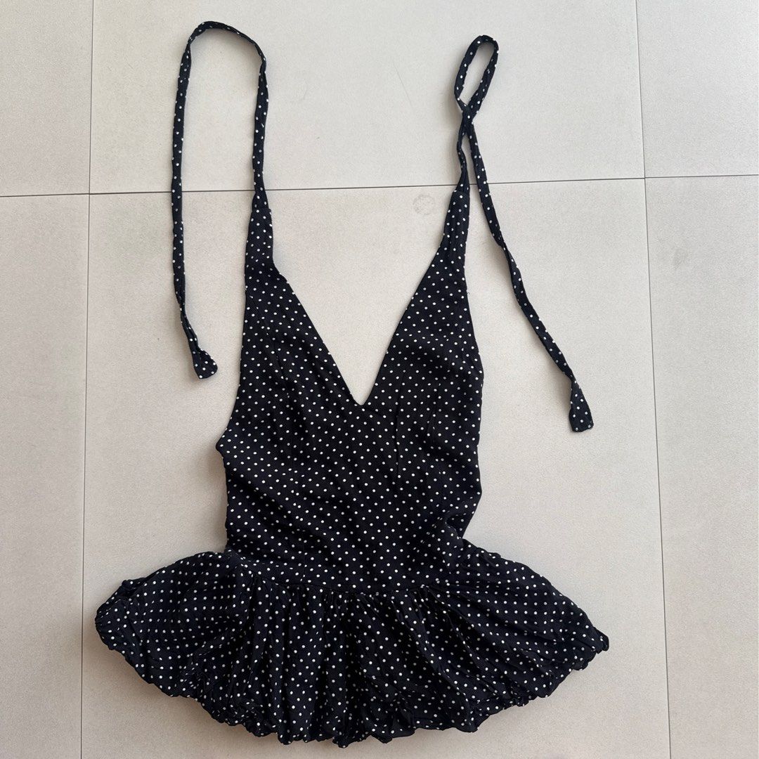 Polka Dot Halter Top (Category: Sleeveless) located in Cebu City. Submitted by strawbeanz (Listing ID 1437460941, Image 1). Description: - Black halter top with white polka dots - V-neckline - Tie-up straps - Ruffled hem - Gathered front detail - Lightweight fabric - Suitable for warm weather - Unique design and flattering silhouette.