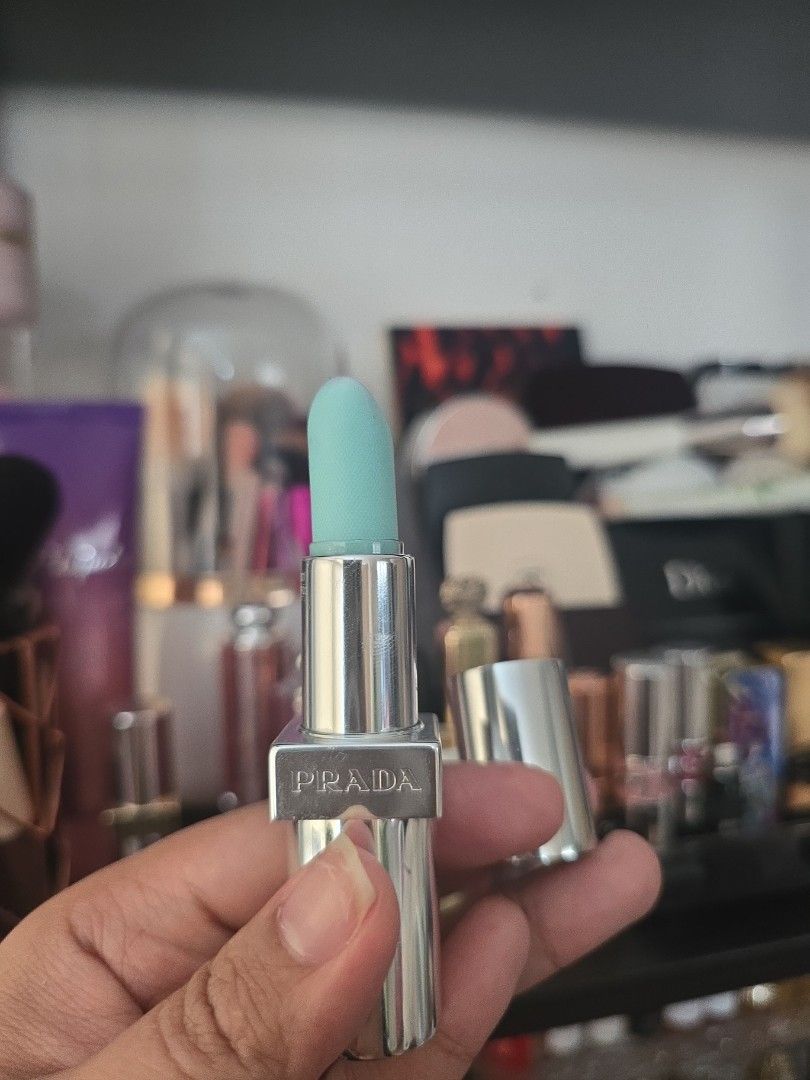 Prada Lipstick (Category: Makeup) located in Taguig. Submitted by jubeiqiao03 (Listing ID 1437476269, Image 1). Description: - Prada lipstick - Silver tube with Prada logo - Light blue lipstick color - Sticker on the bottom of the tube.