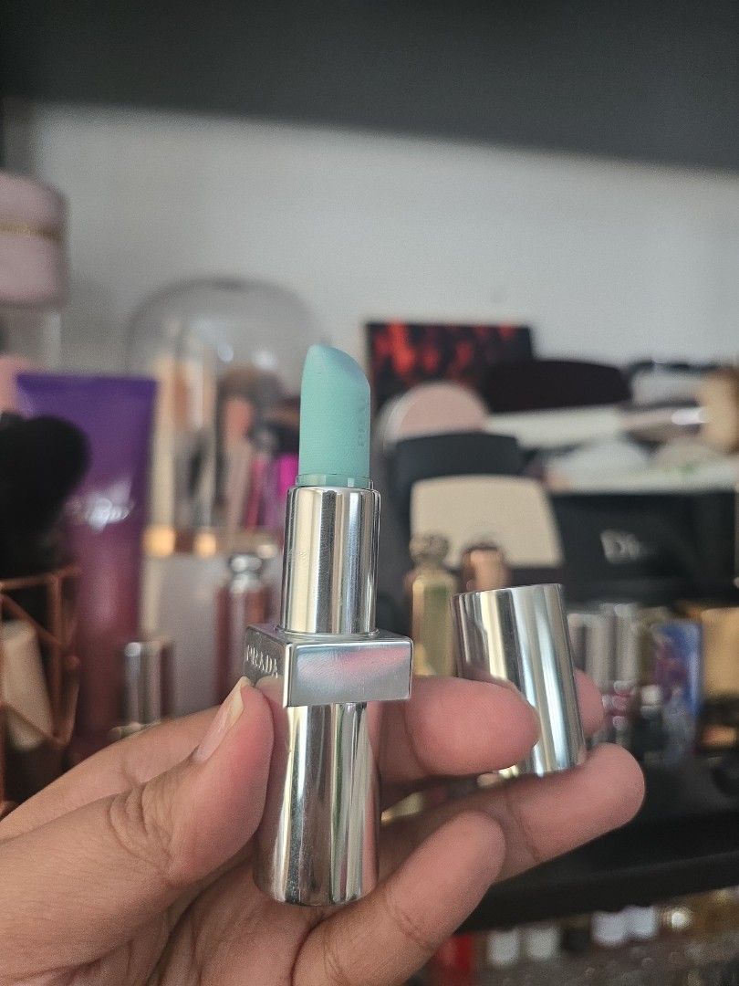 Prada Lipstick (Category: Makeup) located in Taguig. Submitted by jubeiqiao03 (Listing ID 1437476269, Image 2). Description: - Prada lipstick - Silver tube with Prada logo - Light blue lipstick color - Sticker on the bottom of the tube.