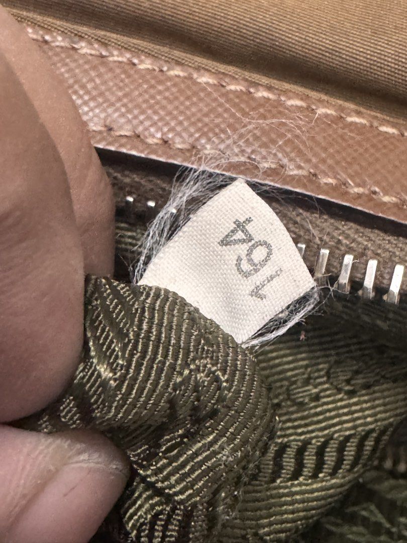 Prada Shoulder Bag (Category: Luxury Bags & Wallets) located in Koronadal. Submitted by milagraciaukayukay123_. (Listing ID 1437558563, Image 2). Description: - Authentic Prada shoulder bag - Brown exterior - Green interior lining - Prada logo - Zipper closure - Includes small leather tag - Shoulder strap - Gold-tone hardware - Zipper marked 'riri M5'.