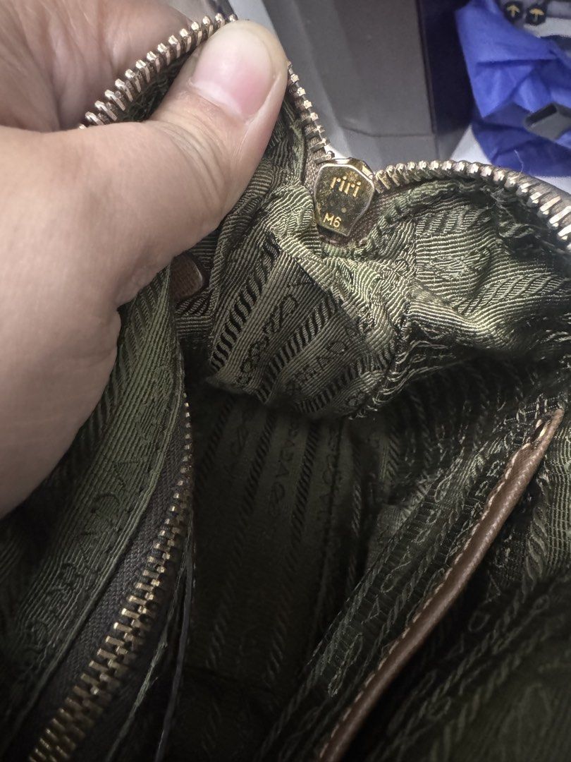 Prada Shoulder Bag (Category: Luxury Bags & Wallets) located in Koronadal. Submitted by milagraciaukayukay123_. (Listing ID 1437558563, Image 3). Description: - Authentic Prada shoulder bag - Brown exterior - Green interior lining - Prada logo - Zipper closure - Includes small leather tag - Shoulder strap - Gold-tone hardware - Zipper marked 'riri M5'.