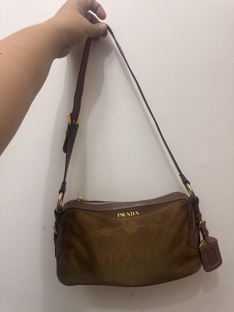 Prada Shoulder Bag (Category: Luxury Bags & Wallets) located in Koronadal. Submitted by milagraciaukayukay123_. (Listing ID 1437558563, Image 1). Description: - Authentic Prada shoulder bag - Brown exterior - Green interior lining - Prada logo - Zipper closure - Includes small leather tag - Shoulder strap - Gold-tone hardware - Zipper marked 'riri M5'.