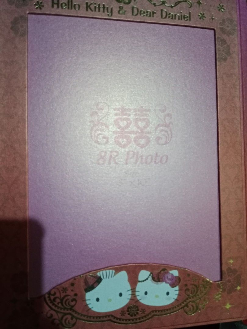 RARE Hello Kitty Marriage Certificate Holder (Category: Stamps & Prints) located in Muntinlupa City. Submitted by periwinklefairy23 (Listing ID 1437470084, Image 3). Description: - Kitty & Dear Daniel themed marriage certificate holder - Features Kitty and Dear Daniel in wedding attire - Red and pink color scheme with gold accents - Includes space for an 8R photo - Features Chinese double happiness symbols.