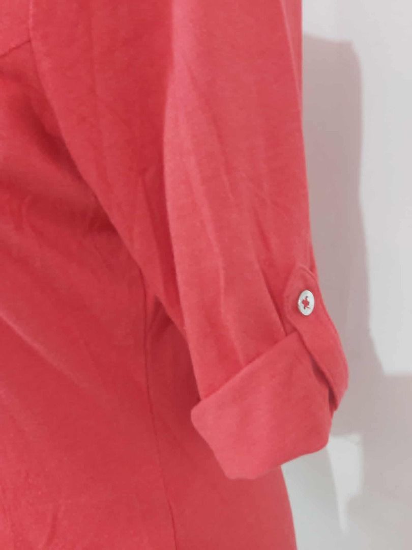 GUESS Red V-Neck Blouse with Zipper Details (Category: Blouses) located in Davao. Submitted by rosewyn (Listing ID 1437540966, Image 2). Description: Red blouse features a V-neck design and three-quarter sleeves. It has silver zipper details on the chest and a button-down front. The sleeves can be rolled up and secured with a button. This blouse is a versatile piece that can be dressed up or down..