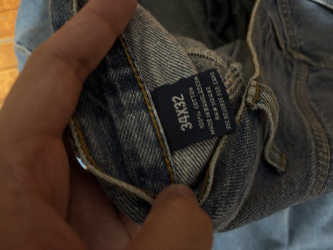 Rural King Carpenter Jeans 34x32 (Category: Jeans) located in Quezon City. Submitted by unusuals_thrift (Listing ID 1437566114, Image 3). Description: Rural King carpenter jeans in a light blue wash. Features a classic five-pocket design with additional carpenter pockets. The jeans are size 34x32 and made of 100% cotton. The Rural King logo is visible on the back pocket. These jeans offer a comfortable fit and a durable construction, perfect for 
