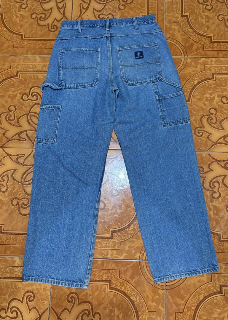 Rural King Carpenter Jeans 34x32 (Category: Jeans) located in Quezon City. Submitted by unusuals_thrift (Listing ID 1437566114, Image 1). Description: Rural King carpenter jeans in a light blue wash. Features a classic five-pocket design with additional carpenter pockets. The jeans are size 34x32 and made of 100% cotton. The Rural King logo is visible on the back pocket. These jeans offer a comfortable fit and a durable construction, perfect for 