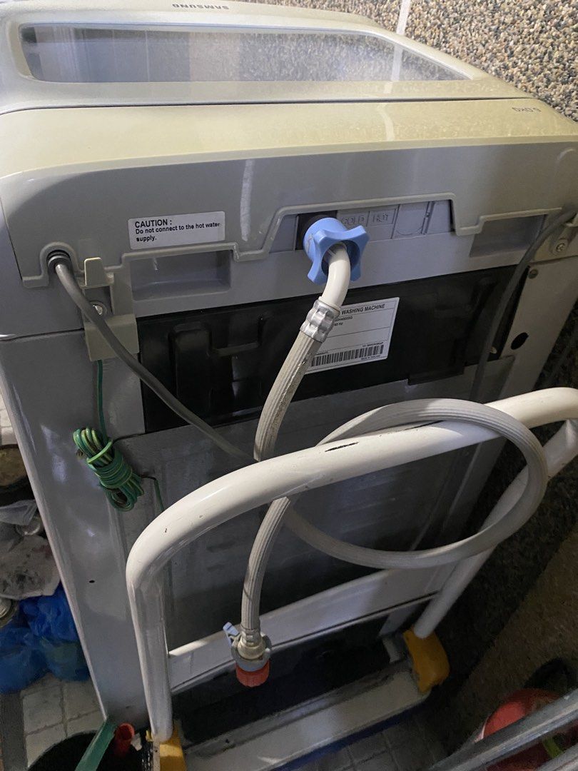 Samsung Top Load Washing Machine (Category: Washing Machines and Dryers) located in Binan City. Submitted by nicadgzmn (Listing ID 1437455431, Image 2). Description: - Samsung top load washing machine - Diamond Drum technology - Wash cycles: Fuzzy, Quick, Delicates - Built-in detergent dispenser - Light grey color - Water inlet connections at the back.