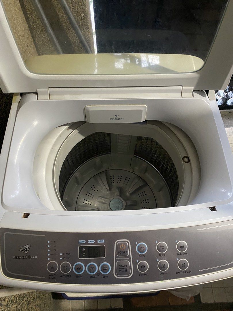 Samsung Top Load Washing Machine (Category: Washing Machines and Dryers) located in Binan City. Submitted by nicadgzmn (Listing ID 1437455431, Image 3). Description: - Samsung top load washing machine - Diamond Drum technology - Wash cycles: Fuzzy, Quick, Delicates - Built-in detergent dispenser - Light grey color - Water inlet connections at the back.