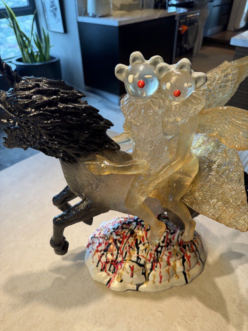 Sculpture 2021 (Category: Other Home Decor) located in Quezon City. Submitted by declutterqueenhigh5 (Listing ID 1437482131, Image 2). Description: - sculpture, dated 2021 - Features a unicorn with a black mane and tail - Two winged figures riding the unicorn - Cloud-shaped base with colorful paint drips - Intricate details and striking design.