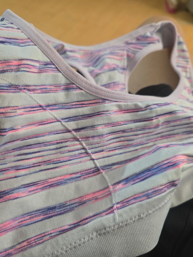 Sports Bra with Striped Design (Category: Babies & Kids Fashion) located in Mandaluyong City. Submitted by mariasdesire (Listing ID 1437444031, Image 1). Description: - Striped sports bra with pink and purple details. - Features a racerback design. - Made from stretchy material for comfort. - Scoop neckline. - Suitable for various workout activities. -Very good condition.