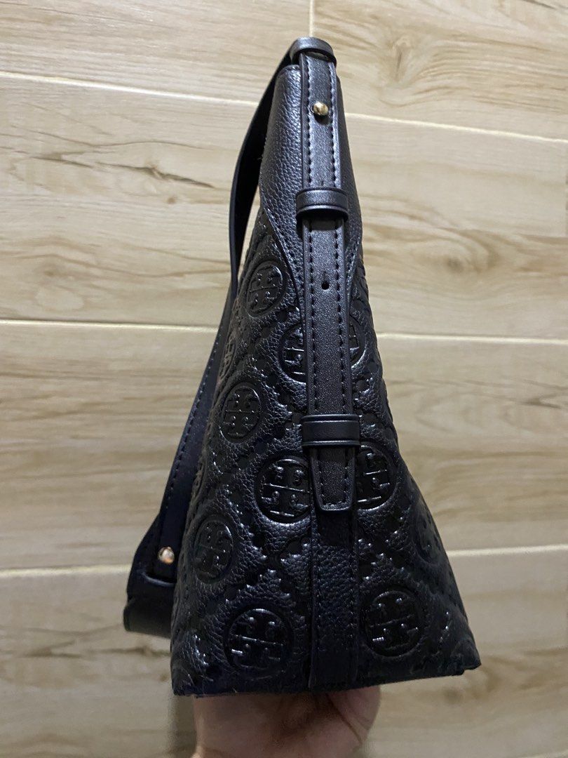 Tory Burch Black Shoulder Bag (Category: Luxury Bags & Wallets) located in Magalang. Submitted by katoenjeru0723 (Listing ID 1437482873, Image 2). Description: - Black shoulder bag - Embossed logo pattern - Top zipper closure - Interior zippered pocket - Shoulder straps - Made of leather - Spacious interior.