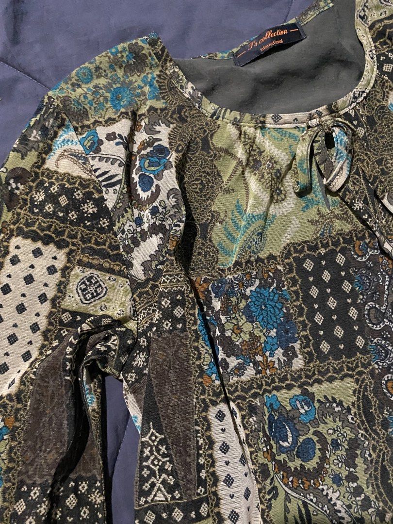 T's Collection International Patchwork Blouse (Category: Blouses) located in Nabua. Submitted by thrift.c4rl0 (Listing ID 1437520343, Image 2). Description: - T's Collection International blouse - Unique patchwork design - Mix of patterns and colors - Long sleeves - Round neckline with tie detail - Lightweight fabric - Comfortable fit - Stylish look - Suitable for various occasions.