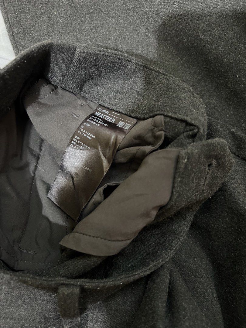 Uniqlo Heattech Gray Pants (Category: Other Bottoms) located in San Jose del Monte. Submitted by sofiah2997 (Listing ID 1437403084, Image 2). Description: These gray pants from Uniqlo feature a Heattech lining. They have a classic, straight-leg cut with pleats at the front. The pants have a button and zipper closure. The size and material composition are indicated on the tag..