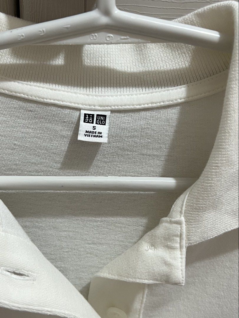 Uniqlo Polo Shirt (Category: Shirts) located in Bustos. Submitted by amcsantos_ (Listing ID 1437553198, Image 2). Description: - Size: Small - Collared neckline with black trim - Button-down placket - Cotton - White.