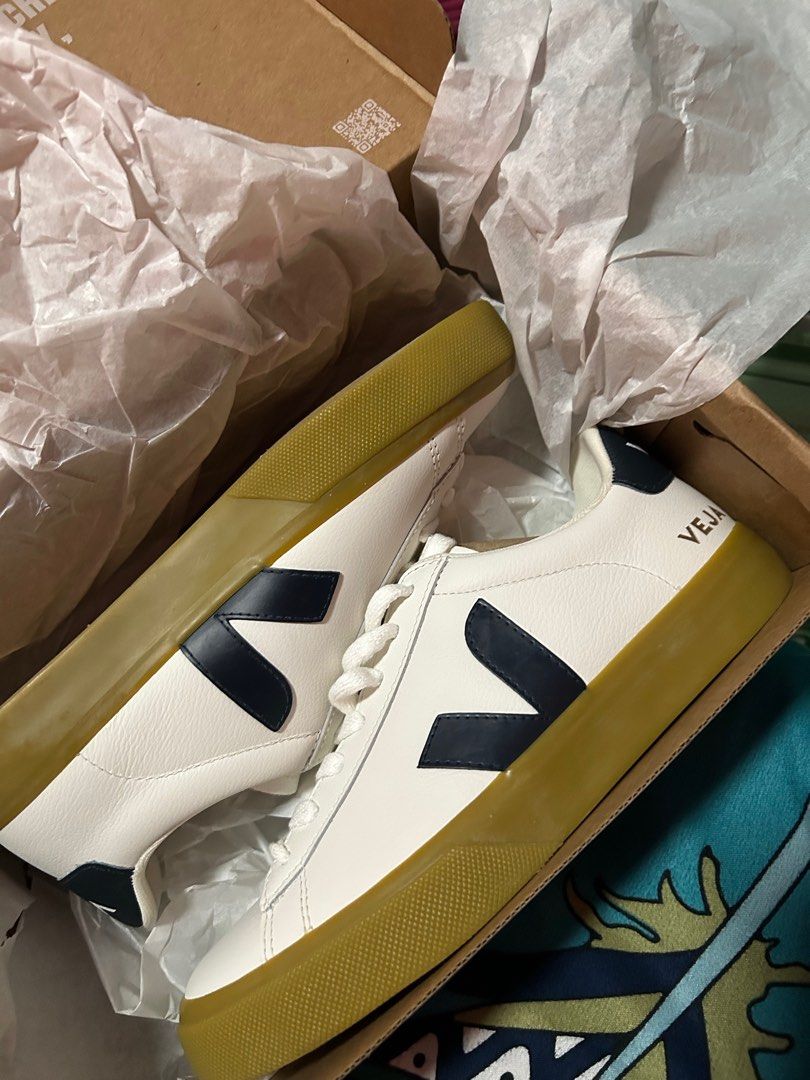 Veja Campo White Navy Sneakers (Category: Sneakers) located in Manila. Submitted by original-preloved-items (Listing ID 1437531454, Image 3). Description: - Veja Campo sneakers - Color: White with navy blue logo - Features a gum sole - White laces - Includes original box and packaging - Veja logo visible on the side.