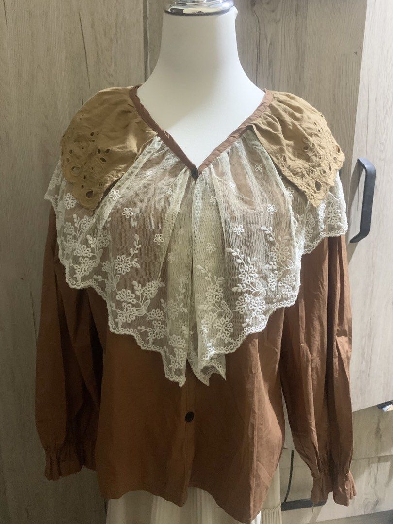 Vintage Brown Blouse with Lace Collar (Category: Blouses) located in Cavite. Submitted by archimage (Listing ID 1437499025, Image 2). Description: - Small - Large - Brown blouse with a unique lace collar and long sleeves - Lace collar features a floral design - Blouse has brown trim around the collar - flaws: pls see pic, really pretty in person 😍.