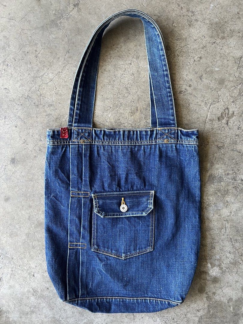 VISVIM - S/S18 SPOT DRY DENIM TOTE BAG (Category: Sling Bags) located in Cavite. Submitted by _Gizmo (Listing ID 1437484106, Image 2). Description: Visvim - S/S18 Spot Dry Denim Tote Bag Made from specially processed denim Dry shrink processed Custom blue selvedge outseam Measurement Width: 14.5’ Inch Length: 15.5’ Inch Depth: 3.5’ Inch Handle: 10’ Inch Used | Very good condition Material: 100% Cotton Made In Japan.