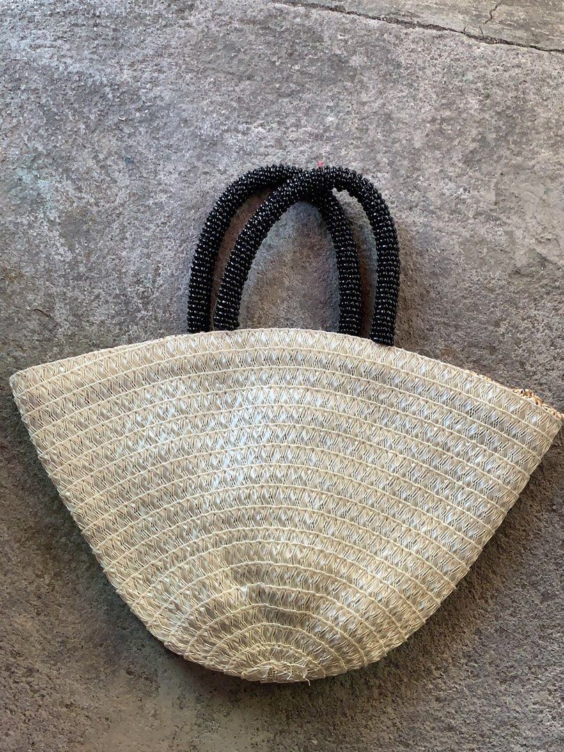 Summer Woven Straw Handbag with Beaded Handles (Category: Beach Bags) located in Manila. Submitted by t.nicole_revilla (Listing ID 1437431226, Image 1). Description: Negotiable - Woven straw exterior - Beaded handles - Patterned fabric lining - Drawstring closure - Lightweight design - Ideal for carrying essentials - Suitable for various occasions Mop: gcash courier: jnt.