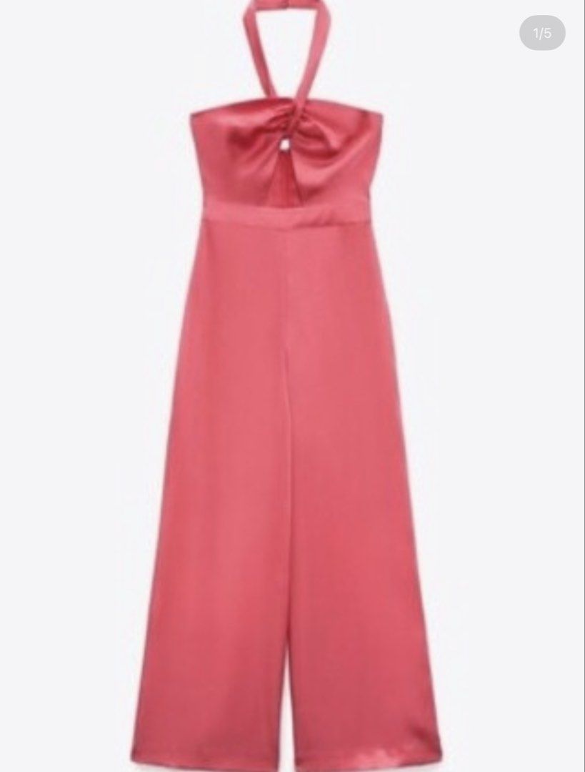 Zara Halterneck Jumpsuit (Category: Jumpsuits) located in Taguig. Submitted by c.preloveditems (Listing ID 1437515748, Image 2). Description: Elegant Zara jumpsuit in a vibrant pink hue. Features a halterneck design with a keyhole detail at the bust. The jumpsuit has a wide-leg silhouette and a concealed zipper closure. Made from a smooth, satin-like fabric. Perfect for special occasions or a night out. RFS: Wrong size BNWOT For sale or trade to 