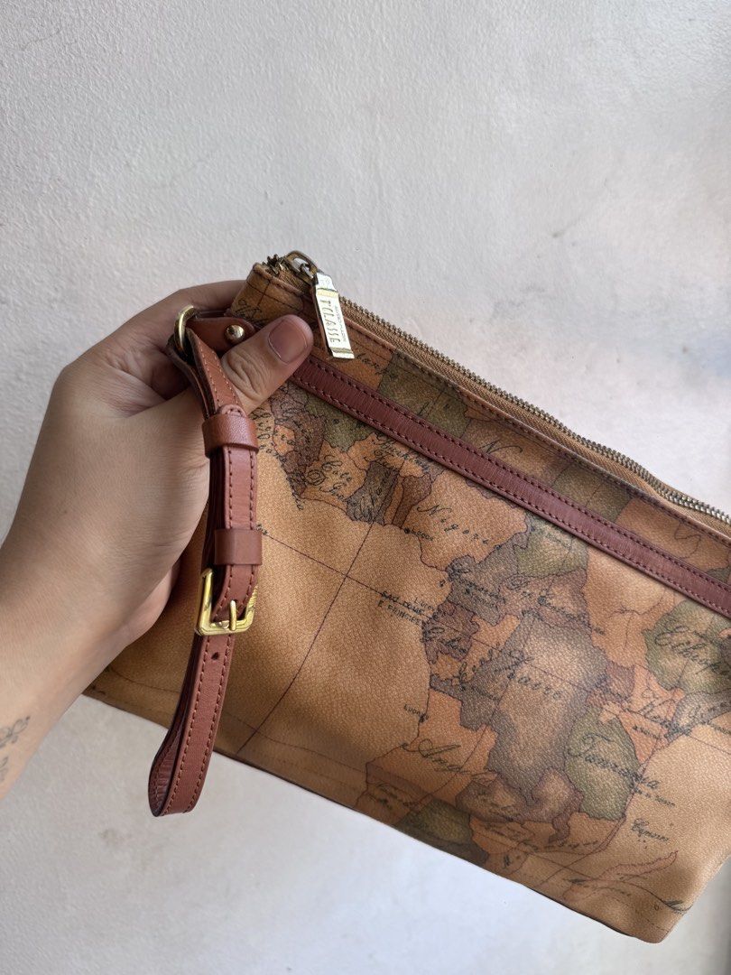 Alviero Martini Clutch bag (Category: Luxury Bags & Wallets) located in Manila. Submitted by thriftyhaven2023 (Listing ID 1437605958, Image 2). Description: - alviero clutch - Unique map print design - Includes wrist strap - Gold-tone zipper - Branded leather tag inside - Minimal signs of wear - Stylish for everyday use 9/10 condition No flaws Kasya long wallet.