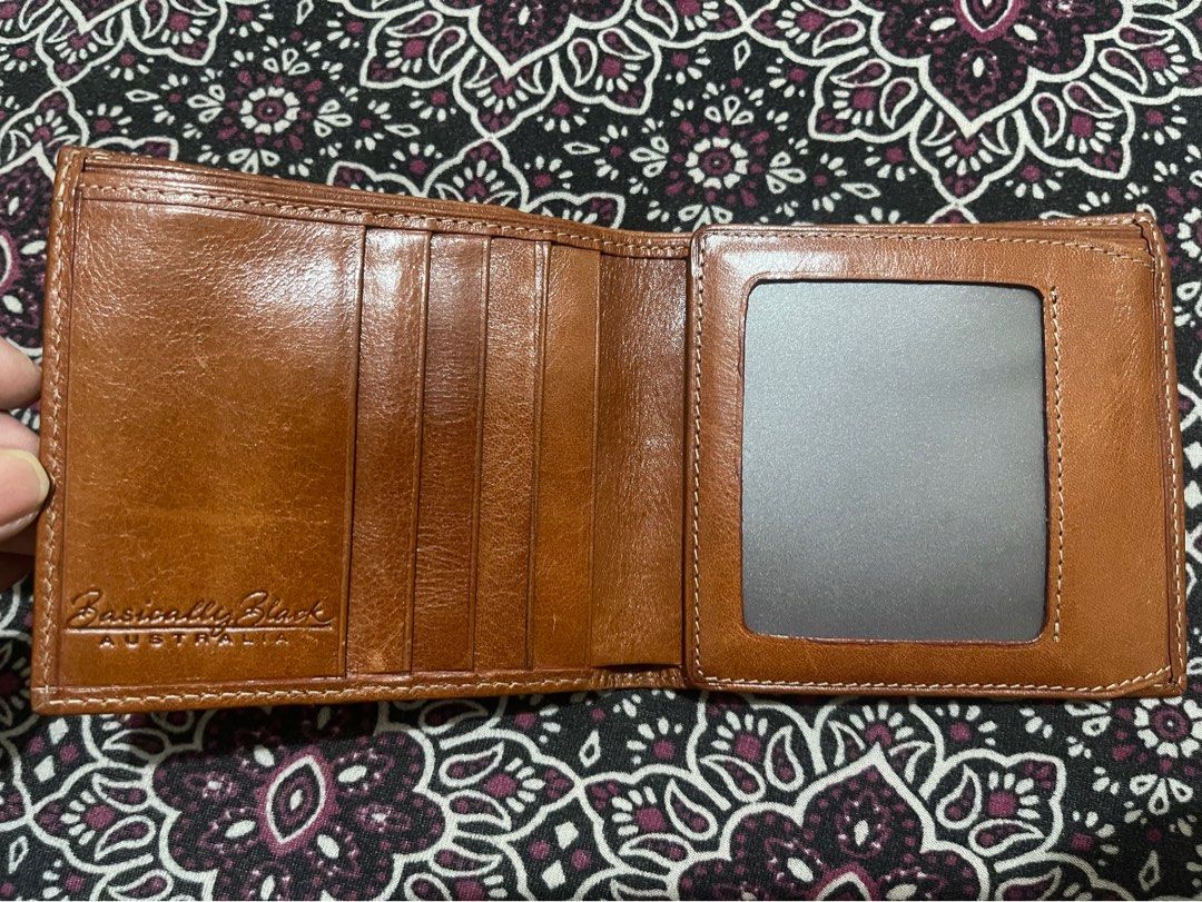 Australian Genuine Leather Wallet (Category: Wallets & Card holders) located in Quezon City. Submitted by minekoh21 (Listing ID 1437685436, Image 2). Description: - Genuine leather Bi-fold wallet - Interior: Brown - Exterior: Decorative emblem - Multiple card slots - Clear ID window - With Zippered compartment for coins - Like New, no issue RFS: Lots of wallets.