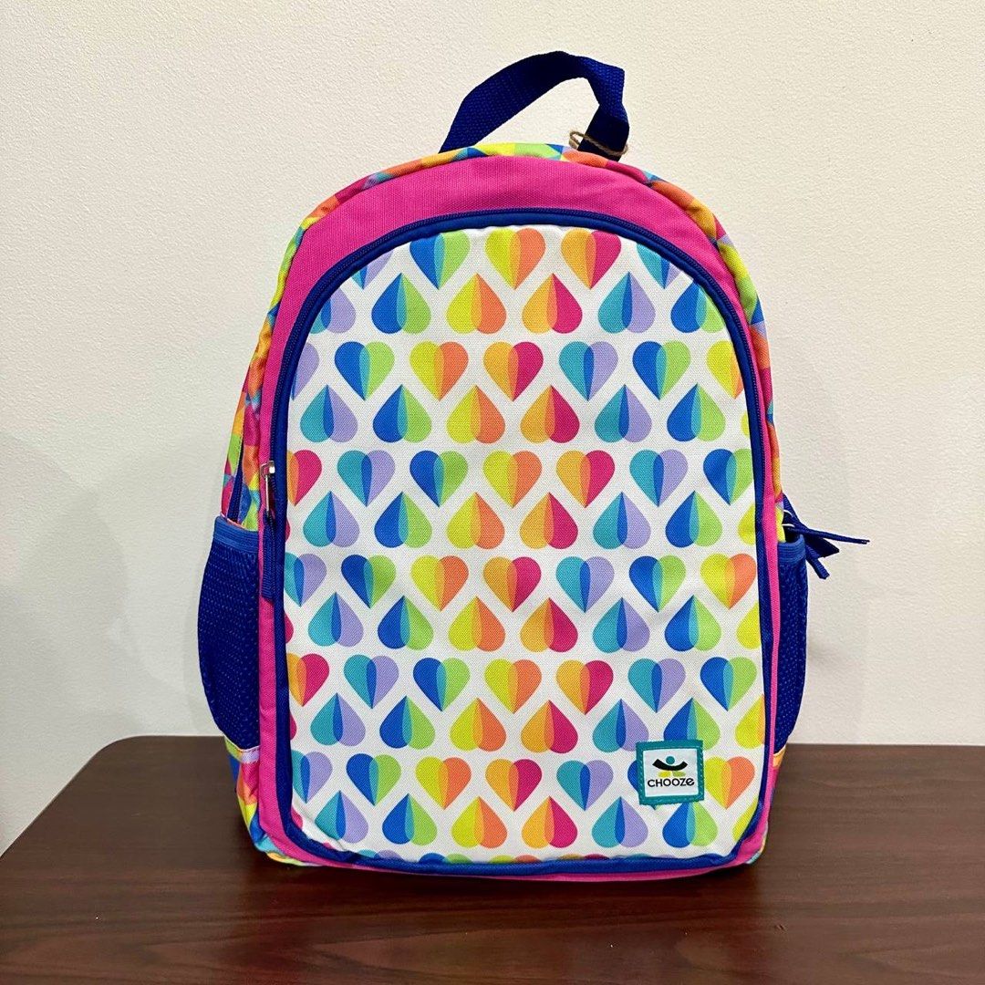 [Authentic] Chooze Reversible Kids Backpack Rainbow Waves & Heart Drops Print Small (Category: Backpacks) located in Quezon City. Submitted by brandedusagoodies (Listing ID 1437639045, Image 2). Description: Bright and playful Chooze reversible kids backpack featuring colorful rainbow wave stripes on one side and rainbow heart drop prints on the other for two fun looks in one bag. Made with durable water-resistant material and padded straps for c