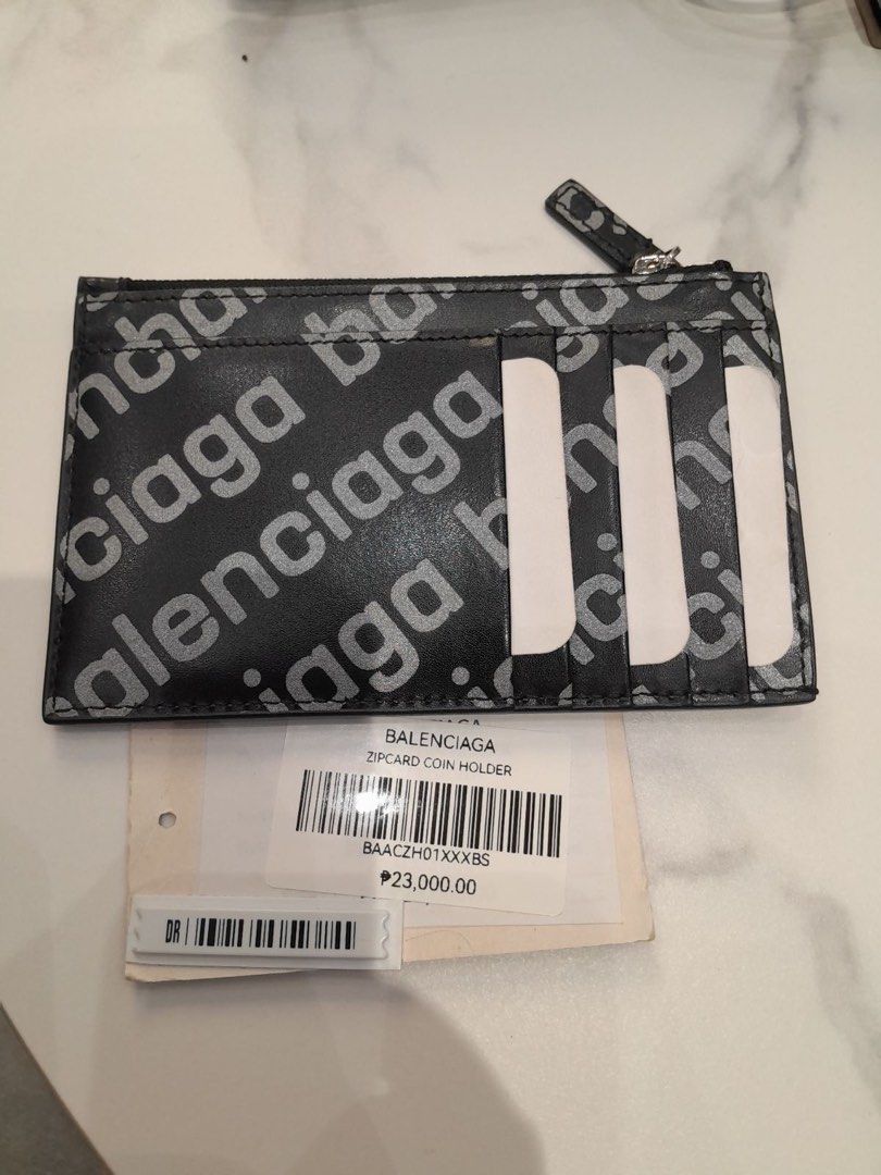 Balenciaga Zip Card Coin Holder (Category: Luxury Bags & Wallets) located in Caloocan City. Submitted by imeldas (Listing ID 1437634317, Image 1). Description: - Authentic Balenciaga Zip Card Coin Holder. - Features the iconic Balenciaga logo. - Includes card slots and a zip compartment for coins. - Compact and stylish design..