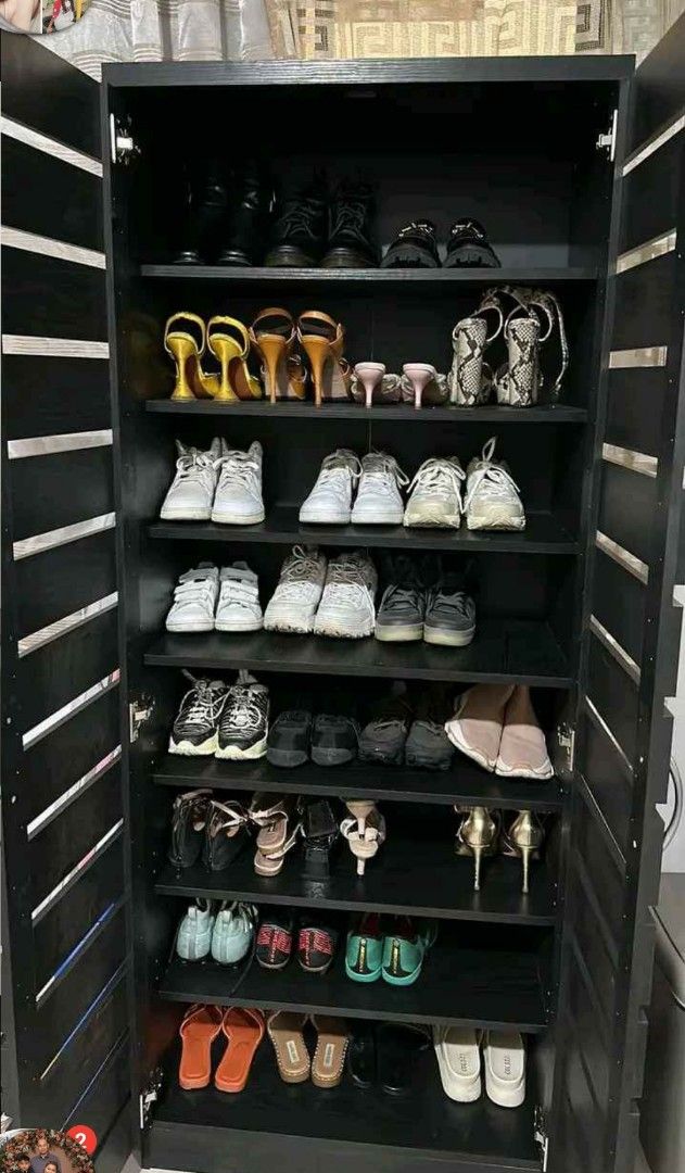 Black Wooden Shoe Cabinet (Category: Shelves, Cabinets & Racks) located in Manila. Submitted by jerrymieborda05 (Listing ID 1437745835, Image 3). Description: - Black wooden shoe cabinet - Multiple shelves for storage - Double-door design - Slatted exterior - Holds various shoe sizes - Sturdy and well-constructed.