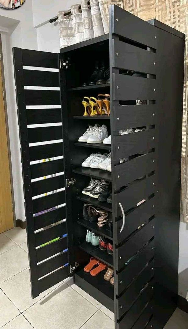 Black Wooden Shoe Cabinet (Category: Shelves, Cabinets & Racks) located in Manila. Submitted by jerrymieborda05 (Listing ID 1437745835, Image 2). Description: - Black wooden shoe cabinet - Multiple shelves for storage - Double-door design - Slatted exterior - Holds various shoe sizes - Sturdy and well-constructed.
