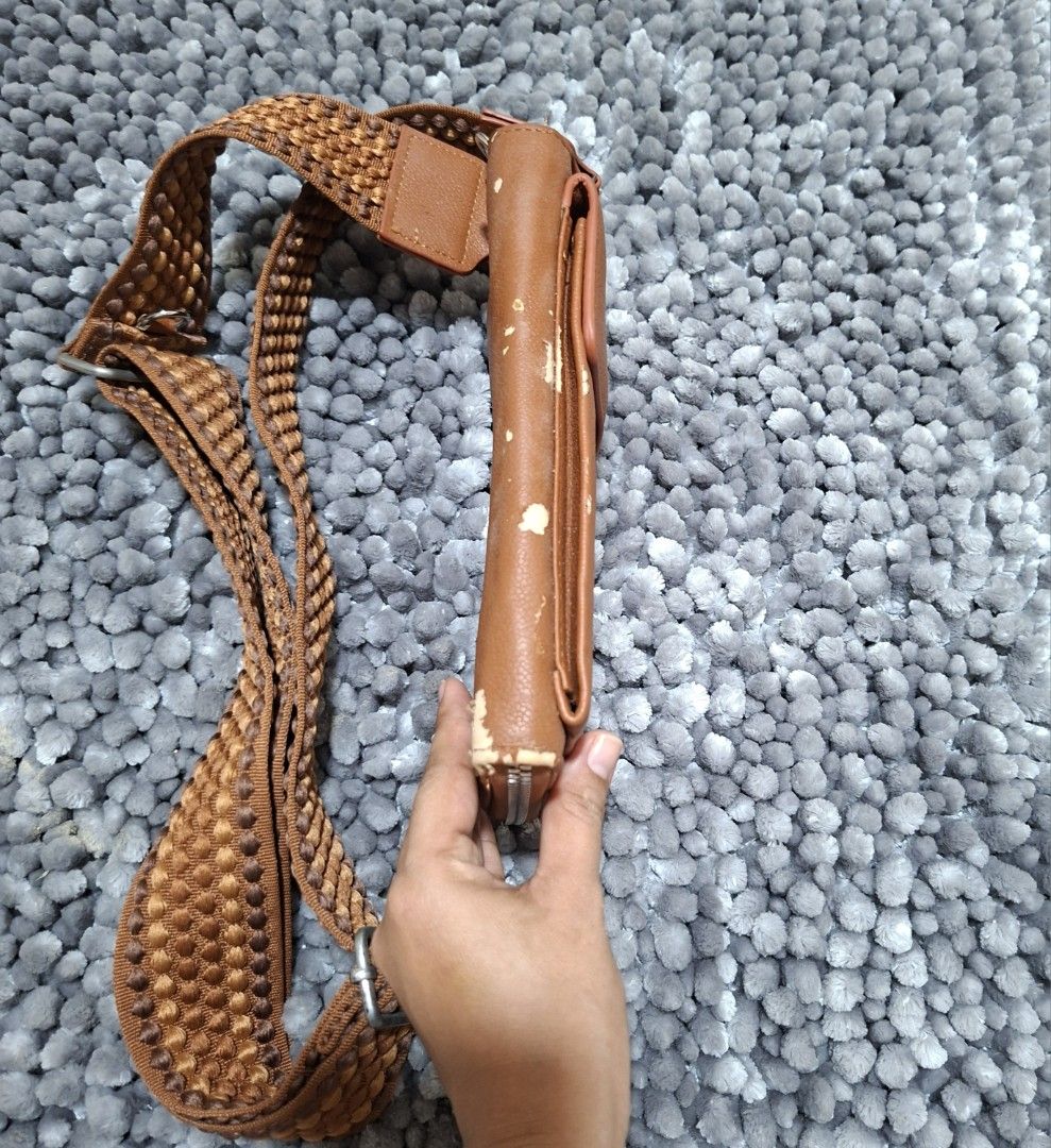 Brown Crossbody Bag with Woven Strap (Category: Cross-body Bags) located in Batangas. Submitted by sell_ph (Listing ID 1437699579, Image 2). Description: - Brown crossbody bag - Woven strap - Zippered main compartment - Multiple card slots - Small inner pocket - Adjustable strap with metal buckle - Shows wear on edges - Practical for everyday use.