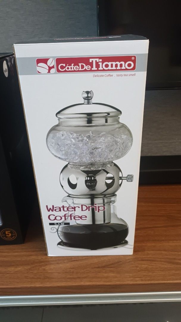 Cafe De Tiamo Water Drip Coffee Maker (Category: Coffee Machines & Makers) located in Mandaluyong City. Submitted by bestill4610 (Listing ID 1437747720, Image 1). Description: - Cafe De Tiamo Water Drip Coffee Maker for cold brew coffee.⁰ - Slow drip "kyoto style" - Features a glass carafe. - Durable stainless steel frame. - Includes a water drip control valve. - Makes 5 cups (600ml) - Silver - Brand new/never used.