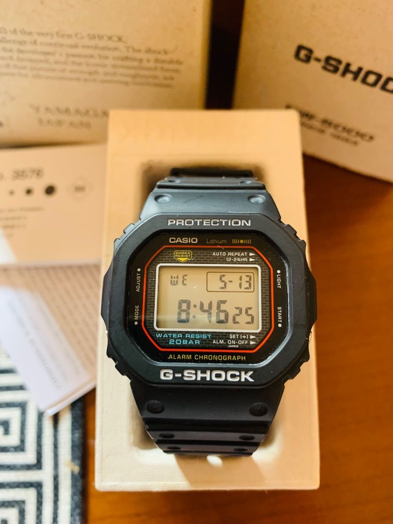 Casio G-Shock DW-5000R (Category: Men's Watches) located in Balingasag. Submitted by earthlythings (Listing ID 1437585271, Image 1). Description: - Authentic Casio G-Shock DW-5000 - Digital display: time, date, day - Includes original box, papers, and packaging - Comes with G-Shock shopping bag - Black strap and case with red accents.