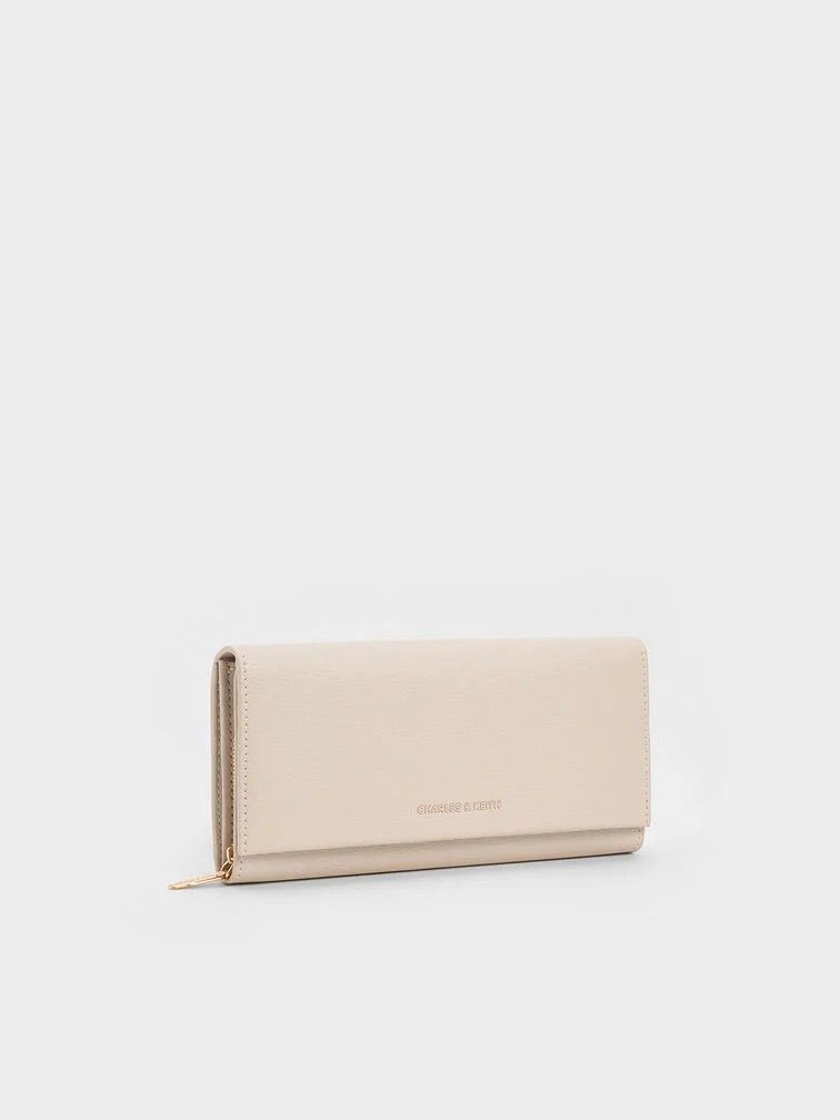 Charles and Keith Muriel Front Flap Long Wallet - Oat (Category: Luxury Bags & Wallets) located in Manila. Submitted by prettyfindsss (Listing ID 1437752800, Image 1). Description: QUICK SPECS: Brand: Charles & Keith Model: Muriel Front Flap Long Wallet - Oat Condition: 10/10 — Excellent, like-new condition. Material: Tumble PU (Faux Leather) with a clean, unembellished exterior. Features: Maximized Organization: Includes 18 card slots and 2 inne