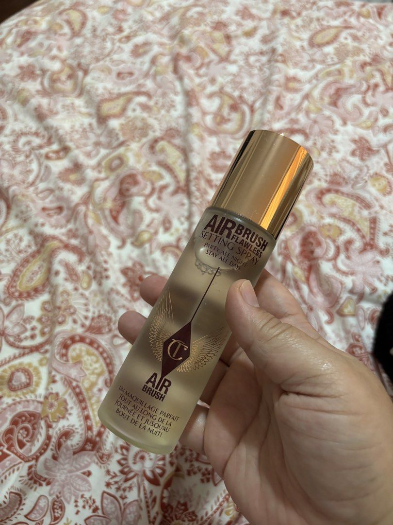 Charlotte Tilbury Airbrush Flawless Setting Spray (Category: Makeup) located in Iba. Submitted by rcgpreloves (Listing ID 1437618997, Image 1). Description: - Charlotte Tilbury Airbrush Flawless Setting Spray - Keeps makeup looking fresh all day and night - Provides a flawless finish - Features a light beige bottle with gold accents - Includes the Charlotte Tilbury logo.