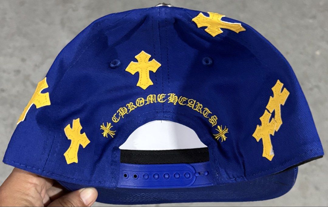 Chrome Hearts CH Blue Gold Cap High Quality Replica (Category: Caps & Hats) located in Hermosa. Submitted by breestyle (Listing ID 1437596184, Image 3). Description: • Royal blue colorway • Clean yellow embroidery • Chrome Hearts style cross patches • Silver top button detail • Adjustable snapback fit • Structured shape and thick material • Actual photos posted Very eye-catching color combination and looks premium in person..