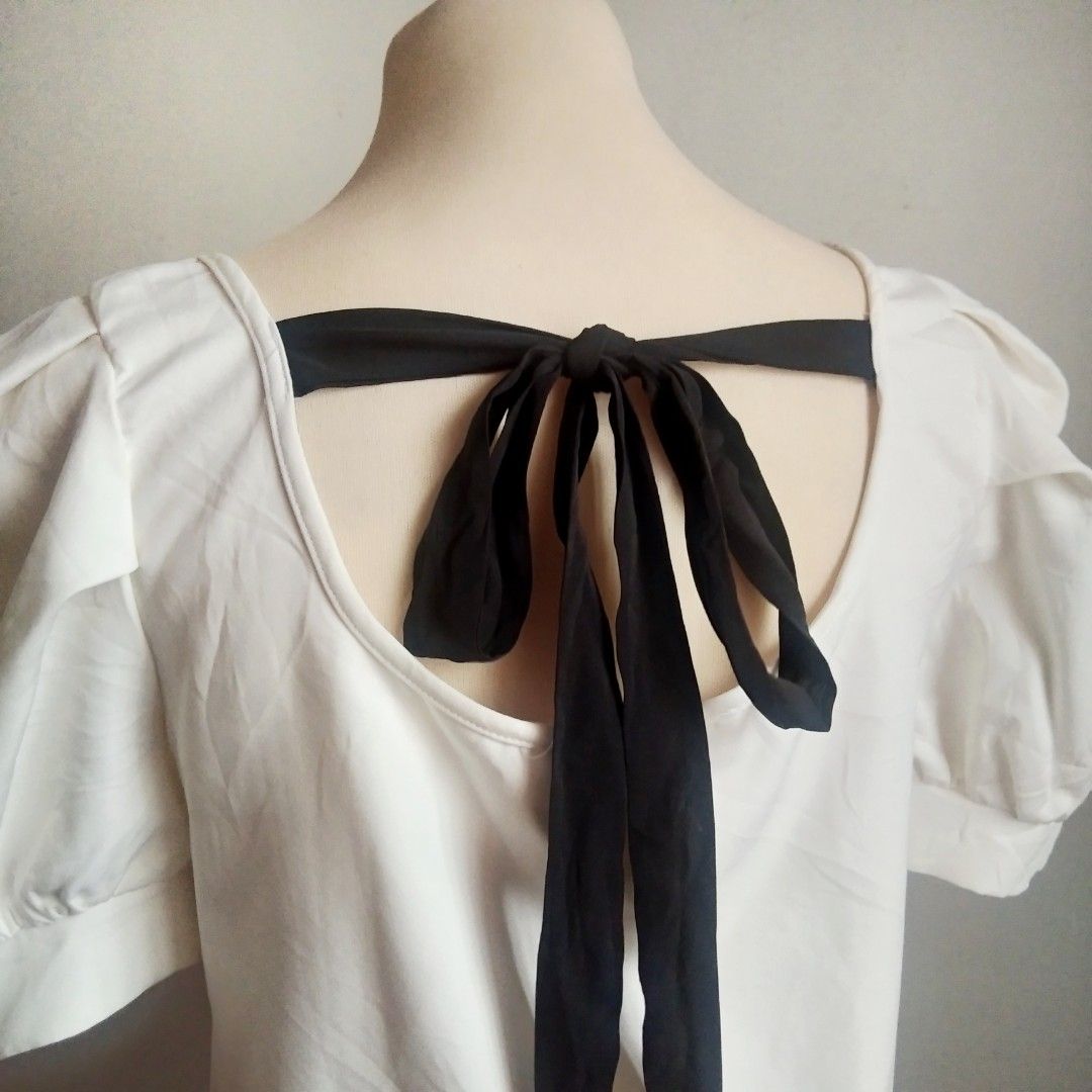Cream White Square Neck Puff Sleeve Blouse (Category: Blouses) located in Manila. Submitted by ixshibixi (Listing ID 1437647358, Image 2). Description: Very good condition Cream white color in actual Black ribbon tie back Fits M-L Width: 18 inches Length: 18 inches Perfect for a chic, feminine look.