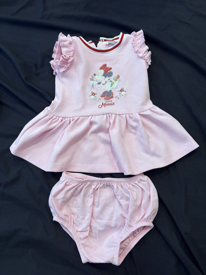 Disney Baby Minnie Mouse Dress Set (Category: Babies & Kids Fashion) located in General Trias. Submitted by irncstnd (Listing ID 1437600675, Image 1). Description: - Adorable baby dress set. - Features a pink dress with Minnie Mouse design. - Includes matching bloomers. - Dress has ruffled sleeves and 'Love Minnie' print. - Designed for babies aged 6-12 months. - Dress has red and white trim. - Made of textured fabric..