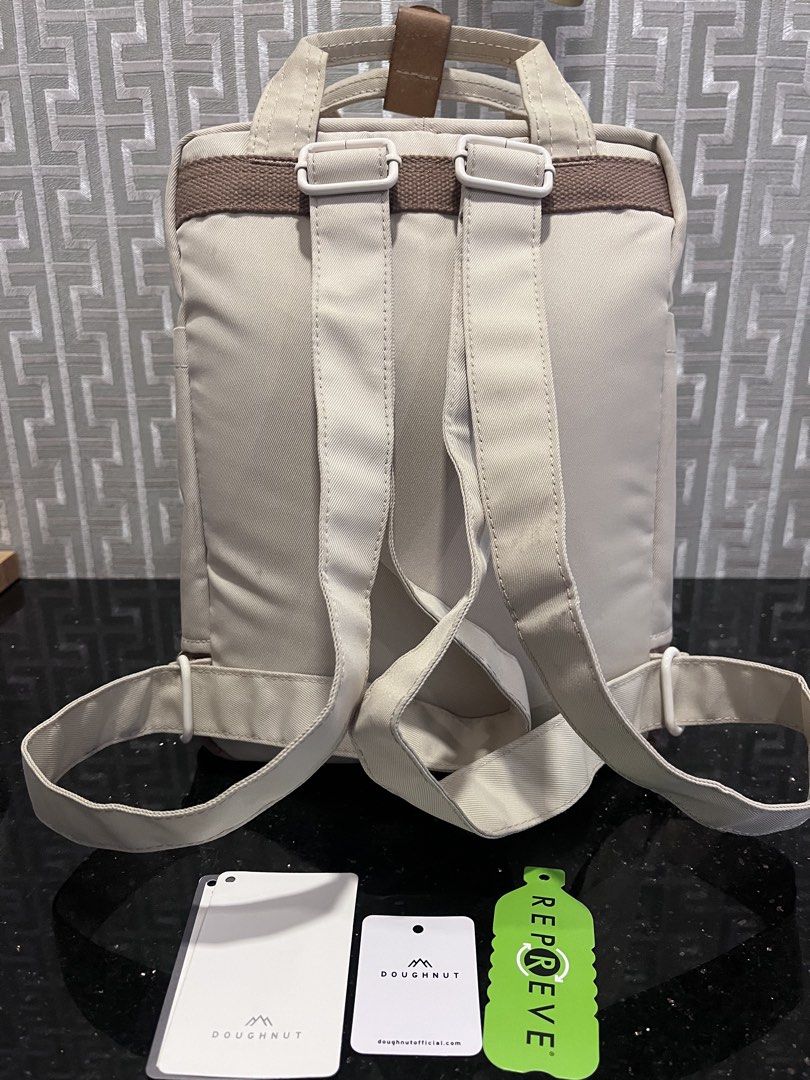 Doughnut Macaron Mini Kaliedo Series Backpack (Category: Backpacks) located in Pasig City. Submitted by jackiedla (Listing ID 1437656472, Image 3). Description: - Original Doughnut Mini backpack - Mushroom Checked Color - Front pocket with Doughnut logo - Adjustable straps - Top handle - Brand new with tags - Color: Beige, brown, and pink.