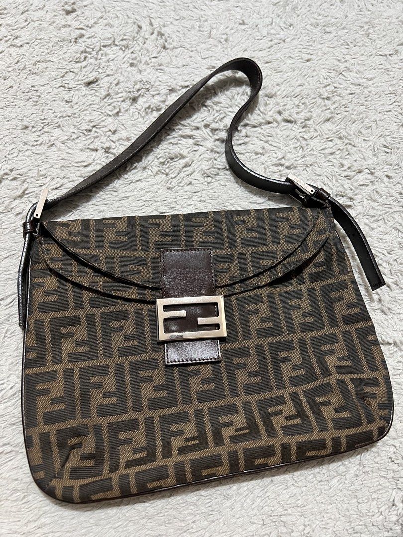 Fendi Zucca Baguette Shoulder Bag (Category: Luxury Bags & Wallets) located in Tarlac. Submitted by irishdenicedabu (Listing ID 1437288875, Image 2). Description: - Authentic Fendi Baguette shoulder bag - Iconic FF logo pattern (brown and black) - Leather shoulder strap - Silver-tone buckle closure - Includes original box and packaging from Sonu Vintage - A stylish and classic accessory - Minor issue barely noticeable - Bought at Sonu 💯 original