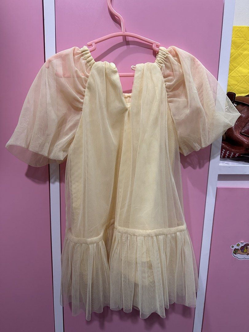 Gingersnaps Yellow Tulle Dress (Category: Babies & Kids Fashion) located in Pasig City. Submitted by wisemomph (Listing ID 1437701954, Image 3). Description: Gingersnaps tiny 12mos on tag. Can fit up to 18-24mos if petite. Super nice in actual. Like new. As is. - Soft yellow tulle fabric - Short, puffy sleeves - Ruffled hem - Includes pink hanger - Perfect for kids!.